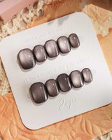 Fume nail art close-up showing taupe brown cat eye details