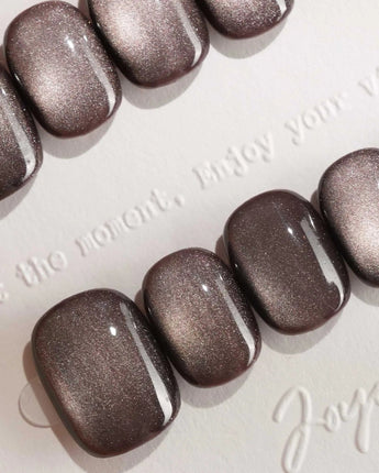 Fume handmade press-on nails featuring taupe brown cat eye