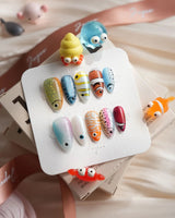 Funky Fish handmade fish nail art with clownfish stripes and bright skittle colors