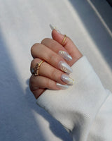 Garden Party nail art close-up showing minimal floral french tip details