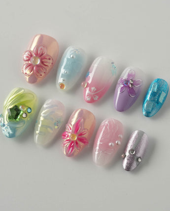 Gem Blossom nails in extra short almond — pastel mix design chrome