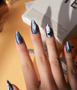 Ghost Errands press on nails with little white ghosts holding a pumpkin, a broom and an umbrella on slate blue cat eye - image 2