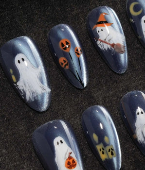 Ghost Errands press on nails with little white ghosts holding a pumpkin, a broom and an umbrella on slate blue cat eye - image 1