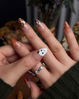 Ghostlight press-on nails in short almond shape — Playful Halloween, Pumpkin & Ghost Glitters.