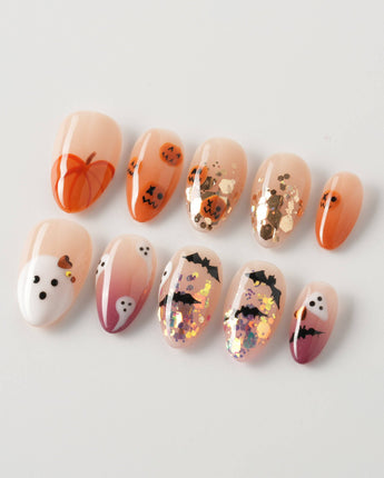 Ghostlight press-on nails in extra short almond shape — Playful Halloween, Pumpkin & Ghost Glitters.
