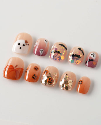 Ghostlight press-on nails in extra short squoval shape — Playful Halloween, Pumpkin & Ghost Glitters.
