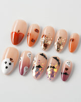 Ghostlight press-on nails in medium almond shape — Playful Halloween, Pumpkin & Ghost Glitters.