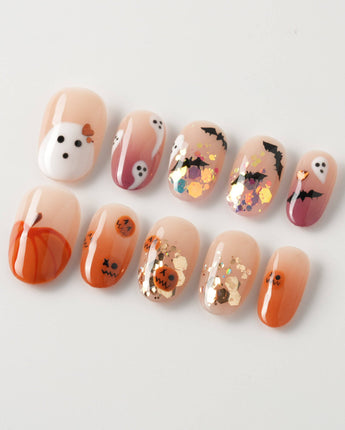 Ghostlight press-on nails in short oval shape — Playful Halloween, Pumpkin & Ghost Glitters.
