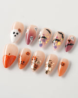 Ghostlight press-on nails in short stiletto shape — Playful Halloween, Pumpkin & Ghost Glitters.