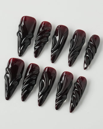 Ghoul Glam press-on nails in long stiletto shape — Dark Red & Black, 3D Liquid Flow.