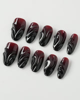 Ghoul Glam press-on nails in medium oval shape — Dark Red & Black, 3D Liquid Flow.
