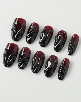 Ghoul Glam press-on nails in medium oval shape — Dark Red & Black, 3D Liquid Flow.