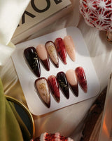 Gilded Merlot press-on nails with burgundy cat-eye shine, gold foil and rose relief details