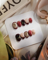 Gilded Merlot extra short oval press-on nails with deep red cat-eye and gold foil details