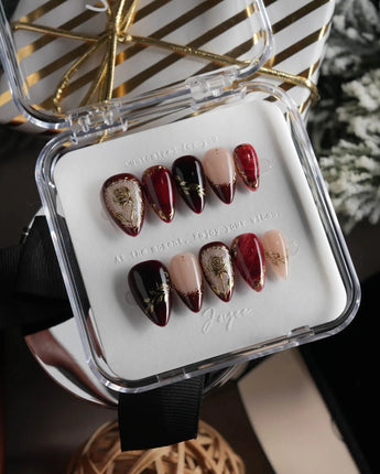 Gilded Merlot short stiletto press-on nails with deep red cat-eye and gold rose reliefs