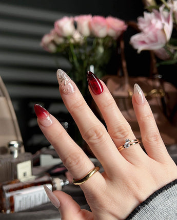 Gilded Rouge short almond press-ons with rich amber red color and raised gold details