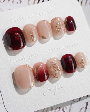 Gilded Rouge in extra short squoval shape with burgundy color and embossed gold leaf