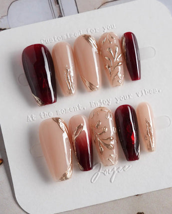 Gilded Rouge in medium coffin shape with warm rouge color and embossed gold leaf art