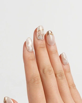 Gilded Truth press-on nails in short oval shape — Minimalist Aurora White, Gold Metallic Outlines & Heart Illustrations.