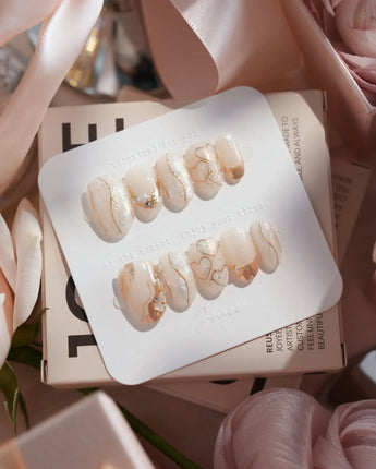 Gilded Truth handmade press-on nails featuring Minimalist Aurora White, Gold Metallic Outlines & Heart Illustrations.