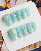 Glass Sea ocean wave press-on nails with mint blue shimmer and pearl accents