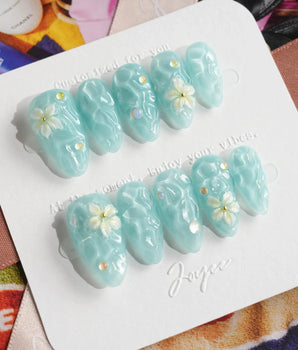 Glass Sea ocean wave press-on nails with mint blue shimmer and pearl accents