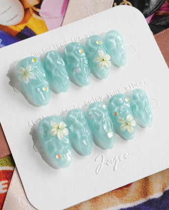 Glass Sea ocean wave press-on nails with mint blue shimmer and pearl accents