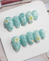 Glass Sea extra short almond nails with water shimmer, 3D flowers, and pearls