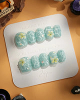 Glass Sea extra short square nails with mint blue cat-eye waves and pearls