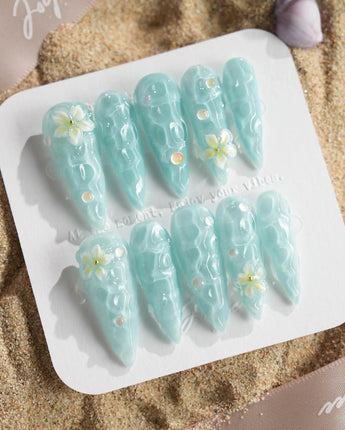 Glass Sea long stiletto nails with ocean wave shimmer and sculpted flowers
