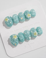 Glass Sea short oval nails with mint blue ripple texture and pearl embellishments