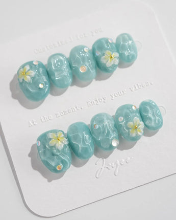 Glass Sea short oval nails with mint blue ripple texture and pearl embellishments