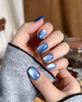 Glass Sky press-on nail set — deep ocean blue cat eye design, hand-painted with real gel polish