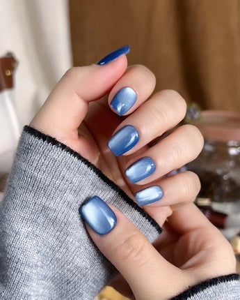 Glass Sky press-on nail set — deep ocean blue cat eye design, hand-painted with real gel polish