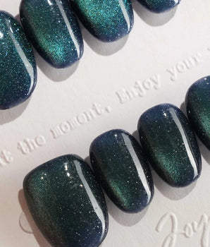Glint Aurora press-on nail set — deep teal cat eye shimmer design, hand-painted with real gel polish