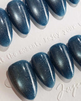 Glint Midnight handmade press-on nails featuring deep teal cat eye shimmer