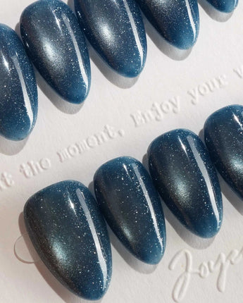 Glint Midnight handmade press-on nails featuring deep teal cat eye shimmer