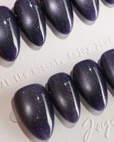 Glint Obsidian handmade press-on nails featuring deep indigo cat eye shimmer