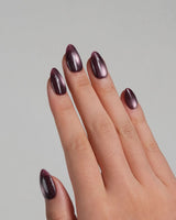 Glint Plum nail art close-up showing deep plum cat eye shimmer details