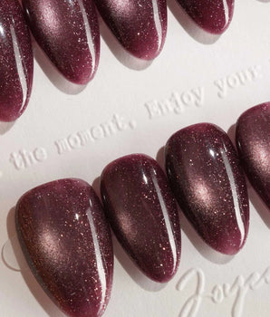 Glint Plum press-on nail set — deep plum cat eye shimmer design, hand-painted with real gel polish