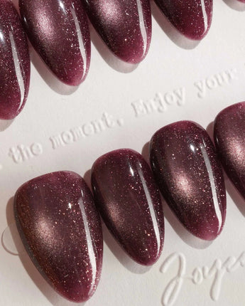 Glint Plum press-on nail set — deep plum cat eye shimmer design, hand-painted with real gel polish
