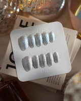 Glitter Frost press-on nails in extra short almond shape — silver glitter