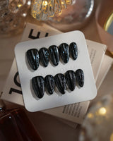 Glitter Logic·Black nails in short almond — Obsidian Black & Aurora