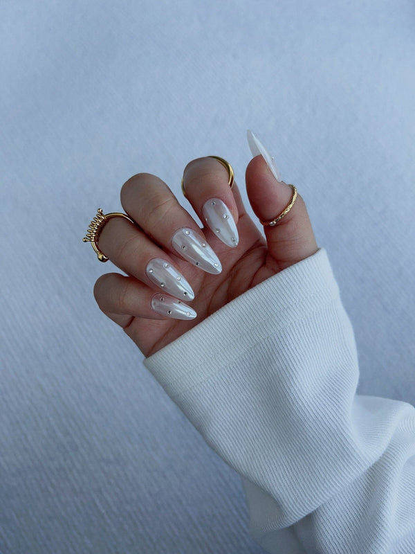 Glitz Galore handmade press-on nails featuring milky white rhinestone nails