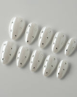 Glitz Galore press-on nails in extra short almond shape — milky white rhinestone nails