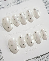Glitz Galore press-on nails in extra short oval shape — milky white rhinestone nails