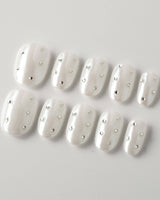 Glitz Galore press-on nails in short oval shape — milky white rhinestone nails
