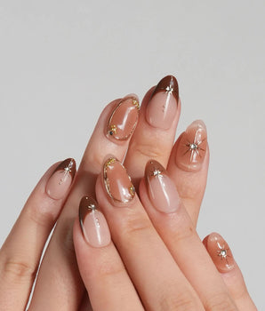 Fall Makeup nail set with caramel brown gradient, 3D gold star accents, and tiny gems
