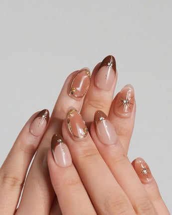Fall Makeup nail set with caramel brown gradient, 3D gold star accents, and tiny gems