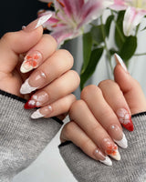 Duchess Marigold glossy press-on set with bold orange 3D floral accents